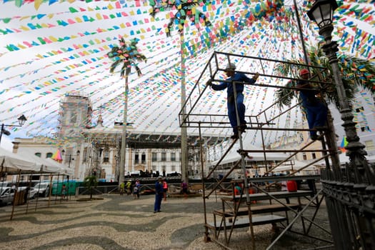 salvador, bahia / brazil - june 19, 2015: Workers are seen working on setting up a stage structure in Pelourinho for the Sao Joao festivities in the city of Salvador....