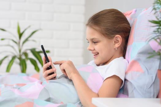 Girl is typing a message in a mobile phone