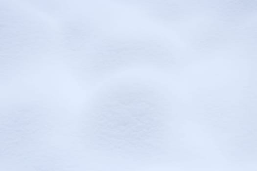 Soft snow hills surface. Snowy mound texture. Winter snowdrift landscape background.