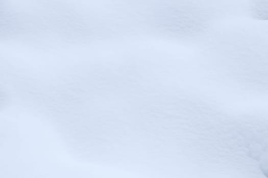 Soft snow hills surface. Snowy mound texture. Winter snowdrift landscape background.