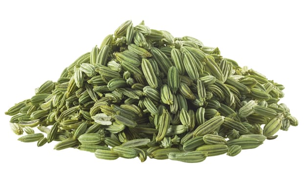Pile of dried fennel seeds (Foeniculum vulgare fruits), isolated