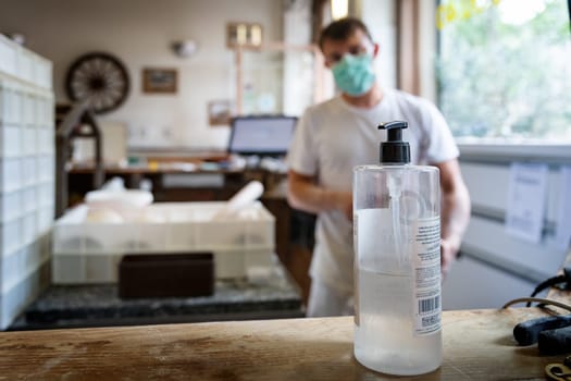 Man is working in a pizza restaurant drive with his mask and covid 19 protection. Pandemic situation