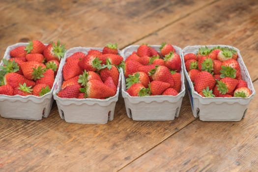 Delicious luxury gourmet food. Ripe bio fruit full of healthy vitamins. Fresh juicy summer harvest in basket row on wooden background.