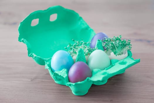 Beautiful decoration easternest basket with painted eggshells for celebration. Lovely traditional gift design on wooden background.