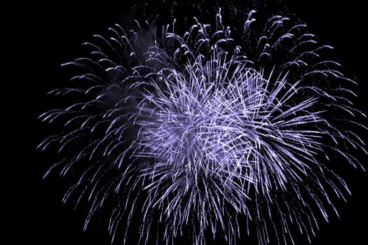 Premium entertainment magic star firework at e.g. New Years Eve or Independence Day party celebration. Black dark night background.