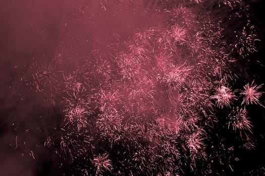 Premium entertainment magic star firework at e.g. New Years Eve or Independence Day party celebration. Black dark night background.