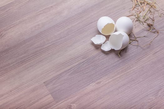 Happy easter basket decoration scene. Traditional handmade easternest deco with straw and white egg for festive holiday celebration.