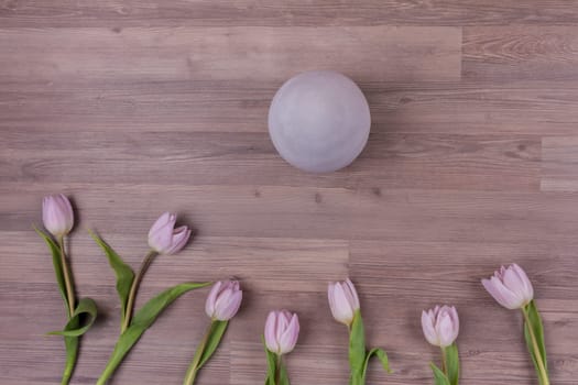 Beautiful decoration easter scene with huge grey egg and pastel flowers for traditional celebration in april. Luxury design wallpaper.
