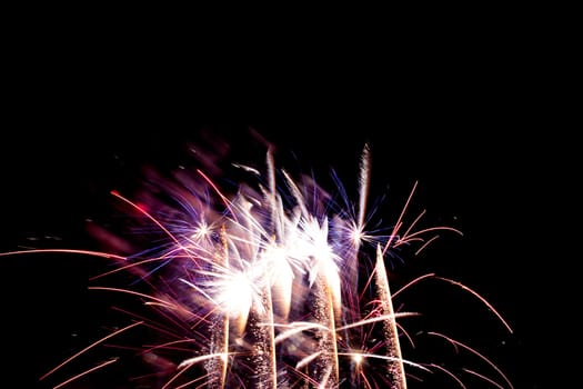 Premium entertainment magic star firework at e.g. New Years Eve or Independence Day party celebration. Black dark night background.