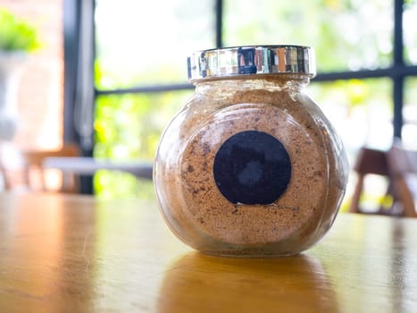 sugar in  glass jar on wood table for coffee.