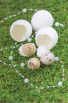Happy easter with hidden nest. Traditional basket deco for celebration. Handmade decoration of chicken and quail egg on green pasture.