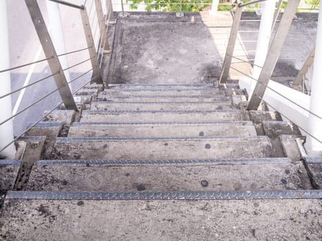 staircase for descending from footbridge. The concrete overpass for crossing the road.