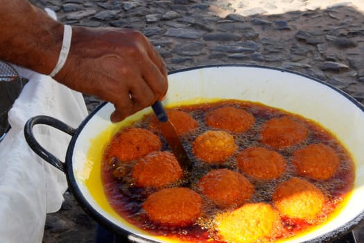 salvador, bahia/ brazil - March 23, 2013: Acaraje is seen during frying in palm oil, in the city of Salvador.