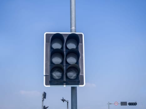 the traffic lights against a vibrant blue sky