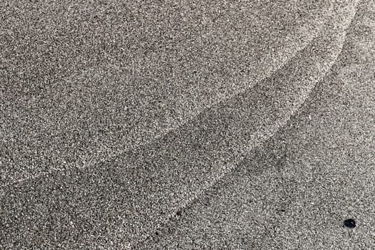 Sand texture pattern and stone. Summer beach background.