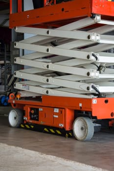 distribution warehouse hall with hydraulic scissors lift platform
