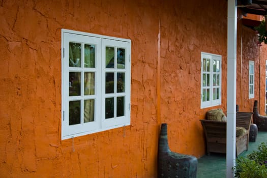 Window With Flower Basket On Orange Wall