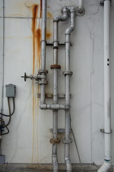 grunge iron pipeline and plumbing connection joints with industrial tap fittings, faucets and valve