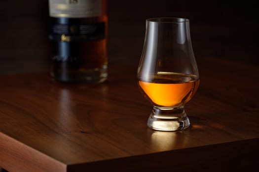 Glencairn whisky on wooden brown table with bottle