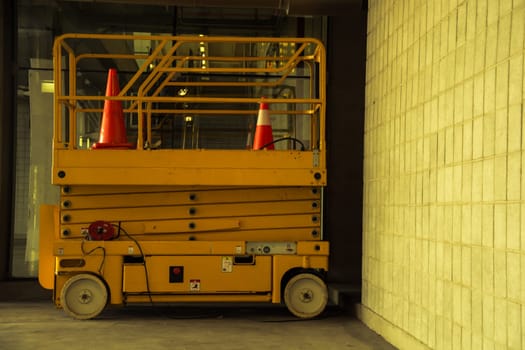 distribution warehouse hall with hydraulic scissors lift platform, vintage color style
