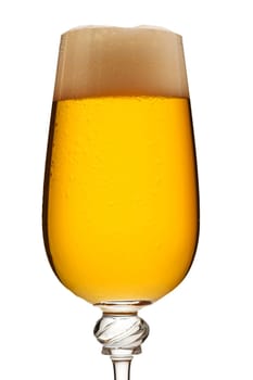 Close-up golden beer with foam in a glass on white