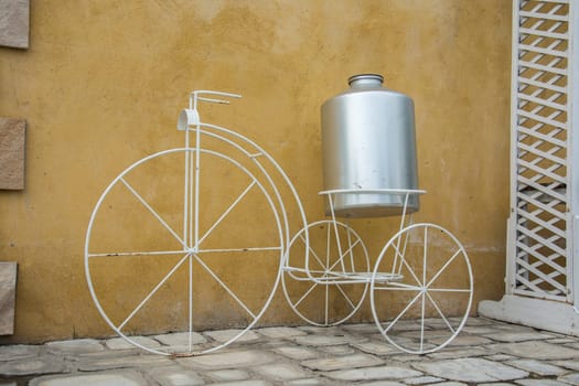 white decor bicycle on the rock wall background.