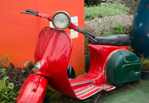 vintage scooter parked in garden,vintage tone