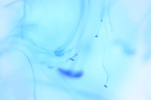 Blue Ink Drips in Clear Water. Soft Ambient Background.