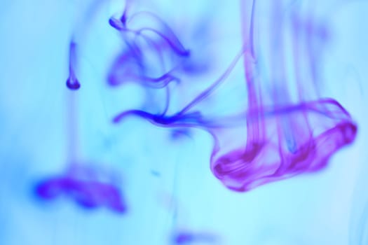 Colored Ink Drops in Water. Ambient Background.
