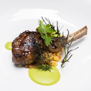 Grilled lamb chop with pesto sauce, international gourmet cuisine a la carte in buffet live station. Using for food and drink industry.