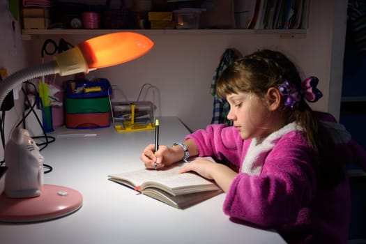 A girl does homework late at night