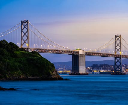 Beautiful sunset with Bay bridge and San Francisco Bay landscape in North California USA West Coast of Pacific Ocean, San Francisco United States Landmark Travel Destination cityscape concept.