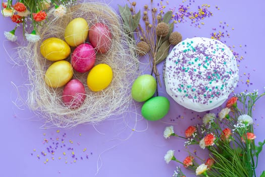 composition of Easter eggs and cake on a purple background