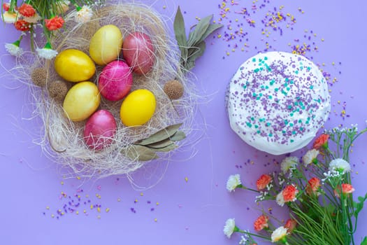 pattern of Easter eggs in the nest and Easter cake on a purple background