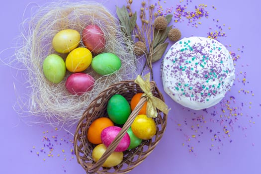 multi-colored Easter eggs in a basket and nest view from above