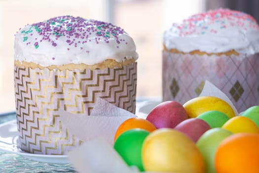 Two Easter cakes and colorful eggs closeup