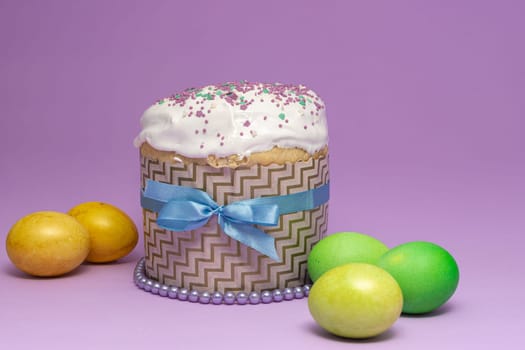 Easter cake pattern with blue ribbon and yellow-green eggs