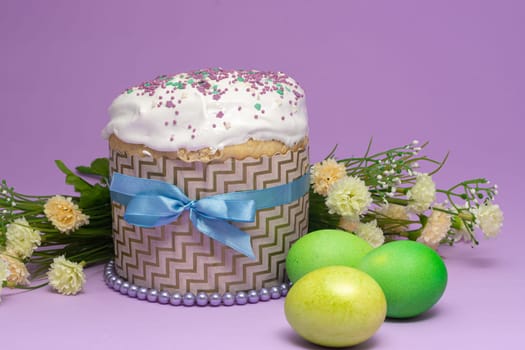 beautifully decorated Easter cake with yellow-green eggs and flowers