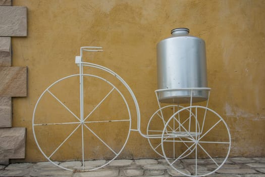white decor bicycle on the rock wall background.