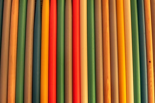 Close up of colored wooden drum sticks arranged in a row