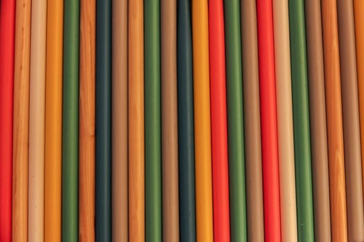 Close up of colored wooden drum sticks arranged in a row