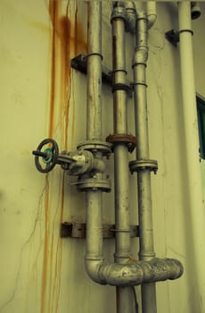 grunge iron pipeline and plumbing connection joints with industrial tap fittings, faucets and valve, vintage color style
