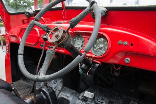 Steering wheel and dashboard in interior of old retro automobile. Processed by vintage or retro effect filter