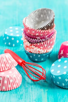 Variation of small paper forms for baking cupcakes and muffins with wisp. Colorful paper liners.