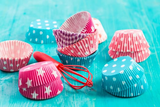 Variation of small paper forms for baking cupcakes and muffins with wisp. Colorful paper liners.