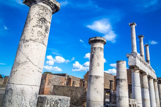 Pompeii in Italy, ruins of the antique Temple of Apollo with bronze Apollo statue, Naples.