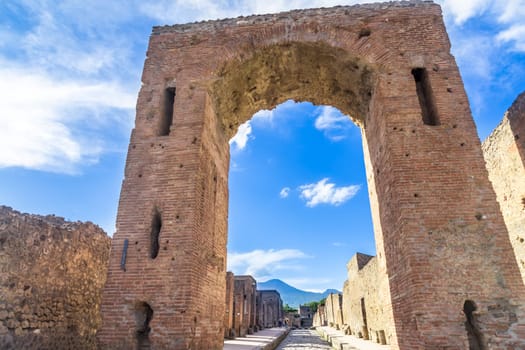 Pompeii in Italy, ruins of the antique Temple of Apollo with bronze Apollo statue, Naples.