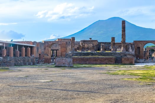 Pompeii in Italy, ruins of the antique Temple of Apollo with bronze Apollo statue, Naples.