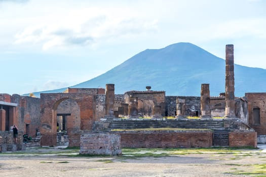 Pompeii in Italy, ruins of the antique Temple of Apollo with bronze Apollo statue, Naples.