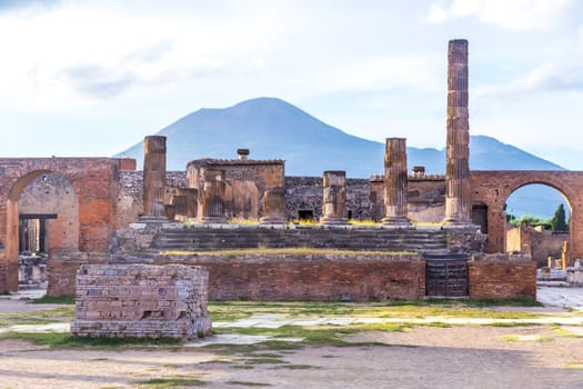 Pompeii in Italy, ruins of the antique Temple of Apollo with bronze Apollo statue, Naples.